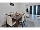 Dining room with table set for four with neutral colors at 1967 Hovenweep Rd, Wesley Chapel, FL 33543