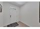 Bright entryway with tiled flooring and a white door, offering a clean and modern welcome at 1967 Hovenweep Rd, Wesley Chapel, FL 33543