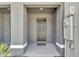 Covered entryway features a modern front door, providing shelter and a welcoming entrance to the home at 1967 Hovenweep Rd, Wesley Chapel, FL 33543