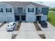 Townhome complex showcases modern facades, driveways, and well-maintained landscaping, creating an inviting community atmosphere at 1967 Hovenweep Rd, Wesley Chapel, FL 33543