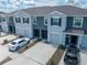 View of the townhome exterior with gray paint, driveway, and attached garage at 1967 Hovenweep Rd, Wesley Chapel, FL 33543