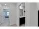 Hallway with doors to bedrooms and bathroom featuring modern fixtures and neutral decor at 1967 Hovenweep Rd, Wesley Chapel, FL 33543