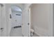 Bright, tiled hallway with a view of the front door and an adjacent half bathroom at 1967 Hovenweep Rd, Wesley Chapel, FL 33543