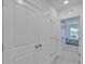 Hallway with carpet and views of a bedroom with lots of natural light at 1967 Hovenweep Rd, Wesley Chapel, FL 33543