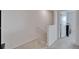 Bright hallway with white walls, neutral carpet, and doorway leading to a bedroom space at 1967 Hovenweep Rd, Wesley Chapel, FL 33543