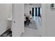 Hallway view leading into the dining and living spaces, with neutral tones and tile flooring at 1967 Hovenweep Rd, Wesley Chapel, FL 33543