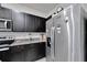 Kitchen with stainless steel fridge and black cabinets at 1967 Hovenweep Rd, Wesley Chapel, FL 33543