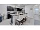 Kitchen island with granite countertops and bar stool seating at 1967 Hovenweep Rd, Wesley Chapel, FL 33543