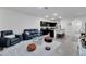 Open-concept living area with stylish furniture and easy access to the kitchen with bar seating at 1967 Hovenweep Rd, Wesley Chapel, FL 33543
