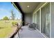Relaxing screened-in patio with seating and a view of the surrounding landscape at 1967 Hovenweep Rd, Wesley Chapel, FL 33543