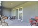 Relaxing screened-in patio with seating and a view of the surrounding landscape at 1967 Hovenweep Rd, Wesley Chapel, FL 33543