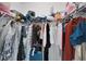 Walk-in closet with wire shelving and a variety of clothes, handbags, and luggage at 1967 Hovenweep Rd, Wesley Chapel, FL 33543