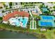 Aerial view showcasing community amenities including pool, clubhouse, bocce ball, tennis courts, and playground at 20647 Ovid Ln, Venice, FL 34293