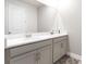 Bathroom featuring a double sink vanity with white countertops and stylish fixtures at 20647 Ovid Ln, Venice, FL 34293