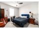 This secondary bedroom offers carpeted floors, a ceiling fan, and side tables with lamps at 20647 Ovid Ln, Venice, FL 34293