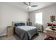 Comfortable guest bedroom featuring carpeted floors, ceiling fan, and a large window at 20647 Ovid Ln, Venice, FL 34293