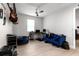 Spacious bedroom featuring light-colored wood flooring, a ceiling fan, and ample space for relaxation at 20647 Ovid Ln, Venice, FL 34293