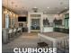 Clubhouse interior with counter height tables, TV and kitchenette; lounge area in background at 20647 Ovid Ln, Venice, FL 34293