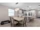 Bright kitchen and dining area with modern chandelier, stainless appliances, and breakfast bar seating at 20647 Ovid Ln, Venice, FL 34293