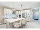 Bright, open kitchen with a large island, stainless steel appliances, and stylish pendant lights at 20647 Ovid Ln, Venice, FL 34293