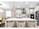 Modern kitchen with a large center island, stainless steel appliances, and pendant lighting at 20647 Ovid Ln, Venice, FL 34293