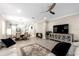 Spacious living room and dining area with modern chandelier, ceiling fan, and luxury vinyl flooring at 20647 Ovid Ln, Venice, FL 34293
