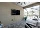 Covered patio with comfortable seating and a view of the screened-in pool area at 20647 Ovid Ln, Venice, FL 34293