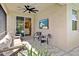 Comfortable outdoor patio with seating, ceiling fan, and tv, perfect for relaxation and entertainment at 20647 Ovid Ln, Venice, FL 34293