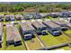Birds eye view of homes with fenced-in yards and a community pond at 22287 Storybook Cabin Way, Land O Lakes, FL 34637