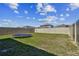 Fenced backyard with a trampoline on a partly cloudy day at 22287 Storybook Cabin Way, Land O Lakes, FL 34637
