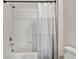 Bathroom features white subway tile shower and patterned gray and white shower curtain at 22287 Storybook Cabin Way, Land O Lakes, FL 34637