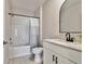 Clean bathroom with a shower over tub, white subway tile, and a vanity with modern black hardware at 22287 Storybook Cabin Way, Land O Lakes, FL 34637
