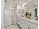 Bright bathroom with a double sink vanity, quartz countertop, shower and tile floors at 22287 Storybook Cabin Way, Land O Lakes, FL 34637