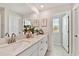 Bright bathroom with double sinks, granite countertops, and modern fixtures, offering ample space at 22287 Storybook Cabin Way, Land O Lakes, FL 34637
