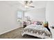 Bright bedroom with a ceiling fan, a vanity desk and a window with natural light at 22287 Storybook Cabin Way, Land O Lakes, FL 34637