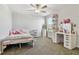 This spacious bedroom showcases a vanity setup with lighted mirror, a shelf, and a large window at 22287 Storybook Cabin Way, Land O Lakes, FL 34637