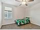 Bright bedroom with a ceiling fan, carpet, and window with natural light at 22287 Storybook Cabin Way, Land O Lakes, FL 34637