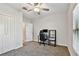 Bedroom features a closet, neutral walls, carpet, window with blinds, and ceiling fan, enhancing the room's appeal at 22287 Storybook Cabin Way, Land O Lakes, FL 34637