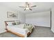 Bright bedroom with a modern ceiling fan, soft carpet, neutral decor, and a comfortable bed creates a welcoming space at 22287 Storybook Cabin Way, Land O Lakes, FL 34637