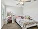 Bright bedroom features a ceiling fan, and a desk with a lighted mirror, adding a unique touch to the room at 22287 Storybook Cabin Way, Land O Lakes, FL 34637