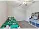 Bright bedroom with a ceiling fan, carpet, closet and white bookcase at 22287 Storybook Cabin Way, Land O Lakes, FL 34637