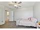 Bright bedroom with a ceiling fan, carpet, and bathroom access at 22287 Storybook Cabin Way, Land O Lakes, FL 34637