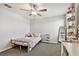 Bright bedroom with a ceiling fan, carpet, desk and shelving at 22287 Storybook Cabin Way, Land O Lakes, FL 34637