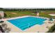 A community pool with lap lanes, lounge chairs, and umbrellas, and walking path at 22287 Storybook Cabin Way, Land O Lakes, FL 34637