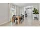 Bright dining area featuring natural light, neutral walls, white tile floors and an open concept floorplan at 22287 Storybook Cabin Way, Land O Lakes, FL 34637