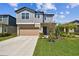 Charming two-story home with a well-manicured lawn and attached two-car garage at 22287 Storybook Cabin Way, Land O Lakes, FL 34637