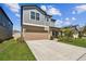 Charming two-story home featuring a two-car garage, neutral color palette and well-manicured landscaping at 22287 Storybook Cabin Way, Land O Lakes, FL 34637