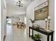Inviting foyer with white tile floors, neutral walls, stairway to second level, and open to dining and living areas at 22287 Storybook Cabin Way, Land O Lakes, FL 34637