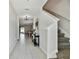 Inviting foyer with white tile floors, neutral walls, stairway to second level, and open to dining and living areas at 22287 Storybook Cabin Way, Land O Lakes, FL 34637