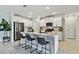 Modern kitchen with white cabinets, stainless steel appliances, and a large island with a breakfast bar at 22287 Storybook Cabin Way, Land O Lakes, FL 34637